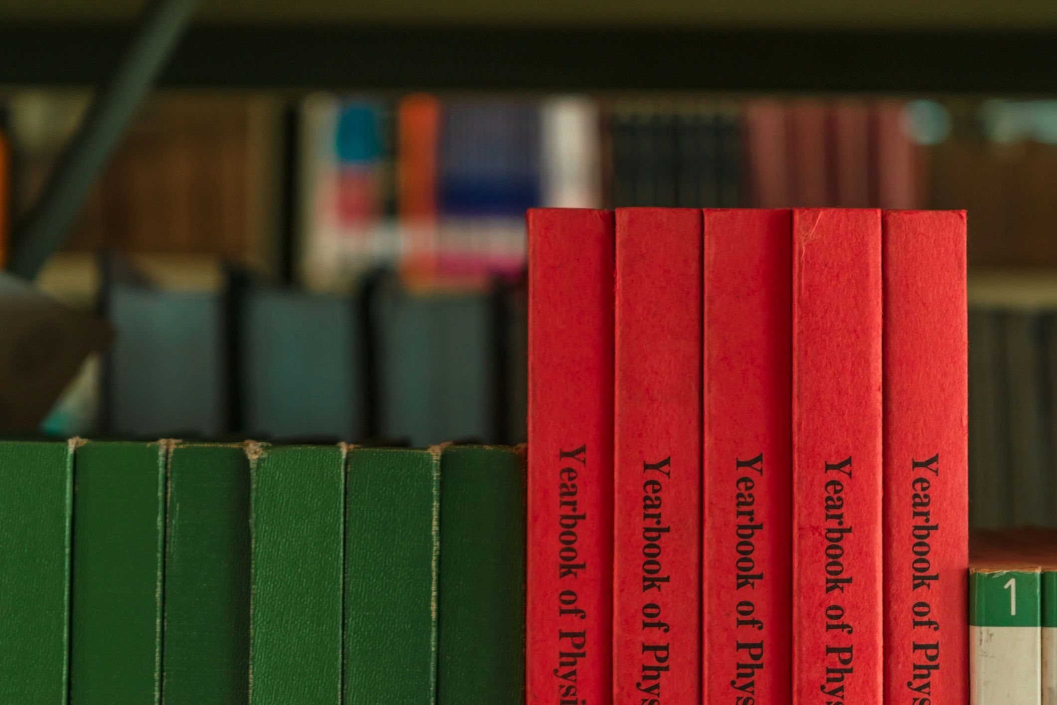 Close up of green and orange books