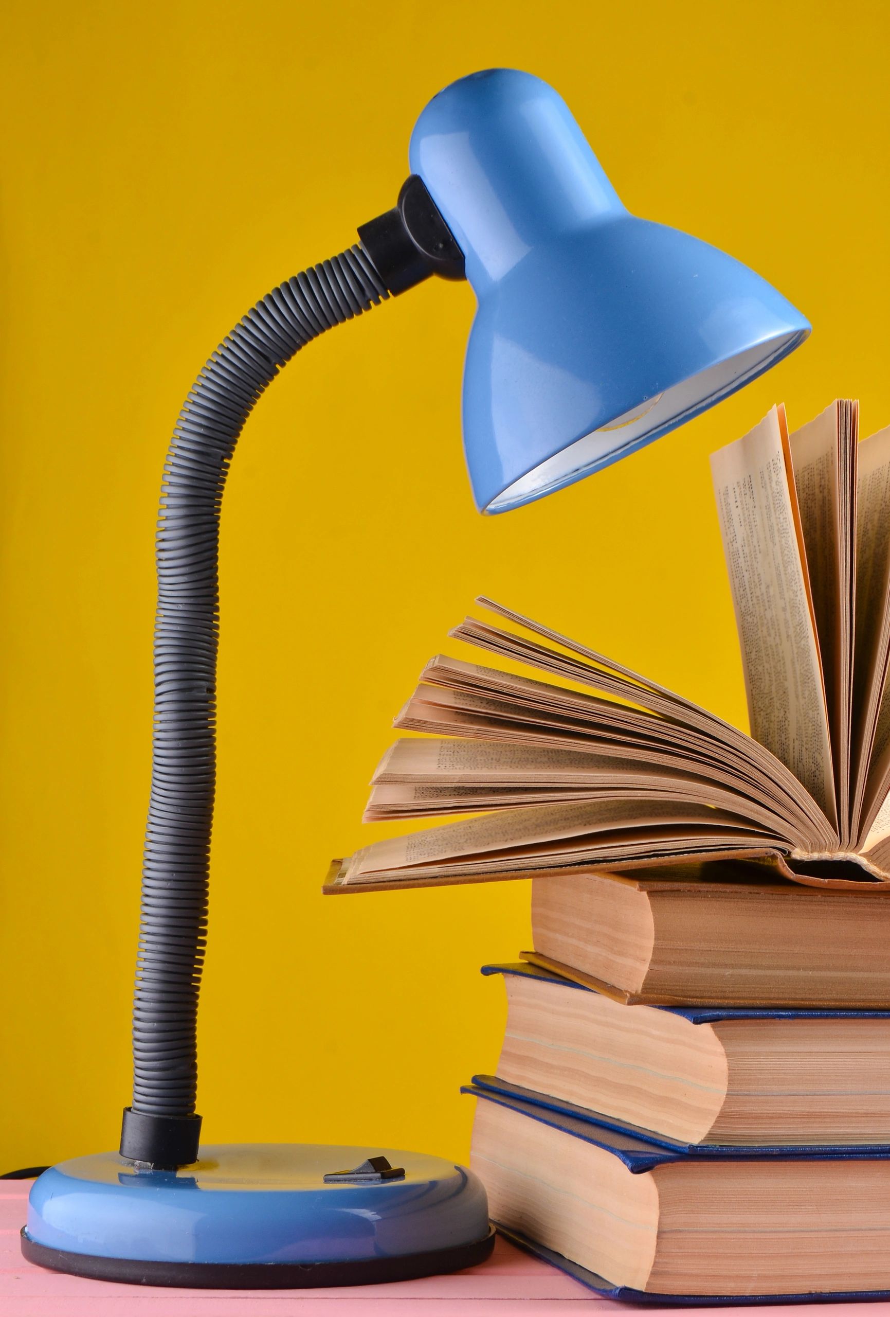 Table lamp beside a stack of books