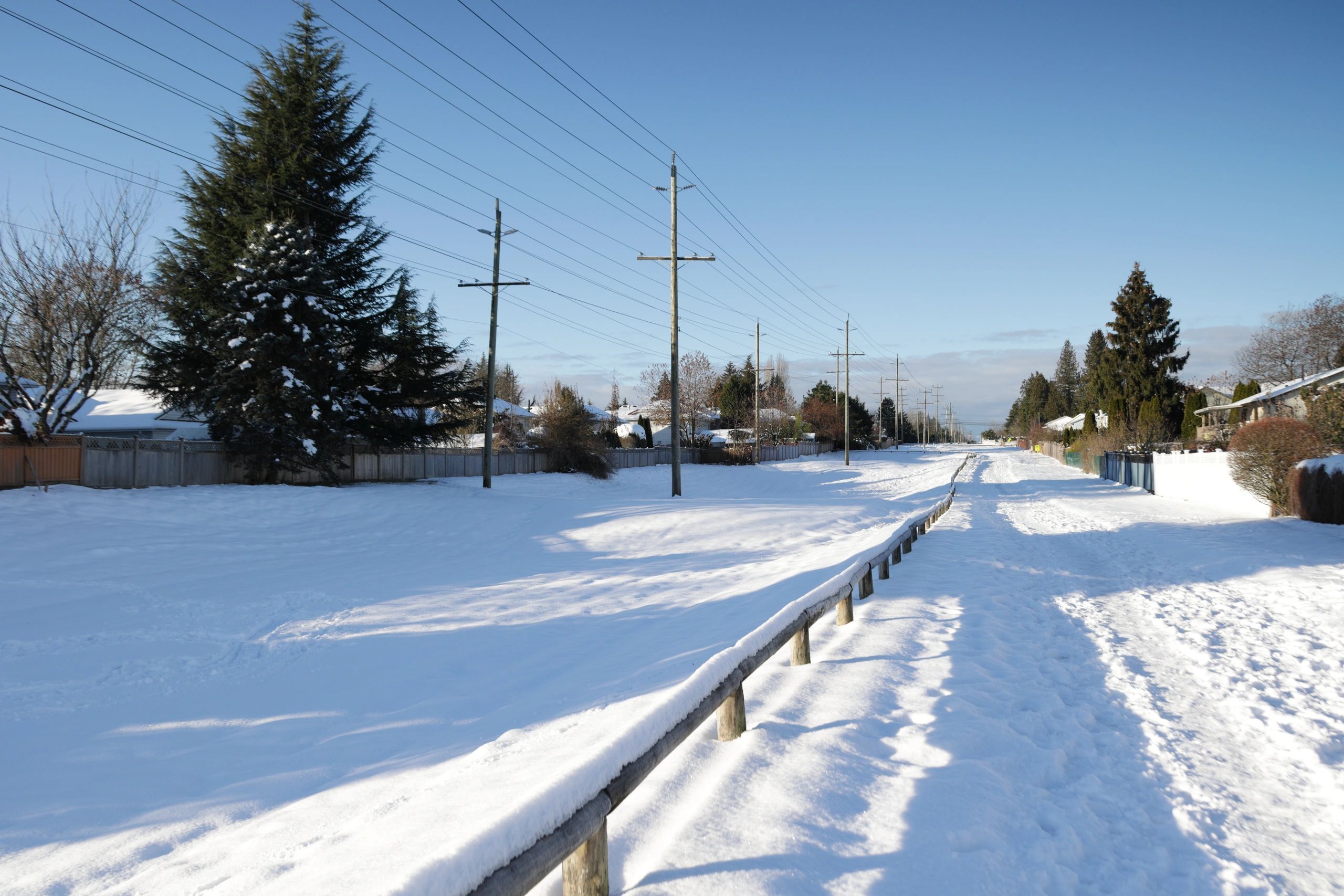 Snowy pedestrian path evoking a quiet lantern-lit lane