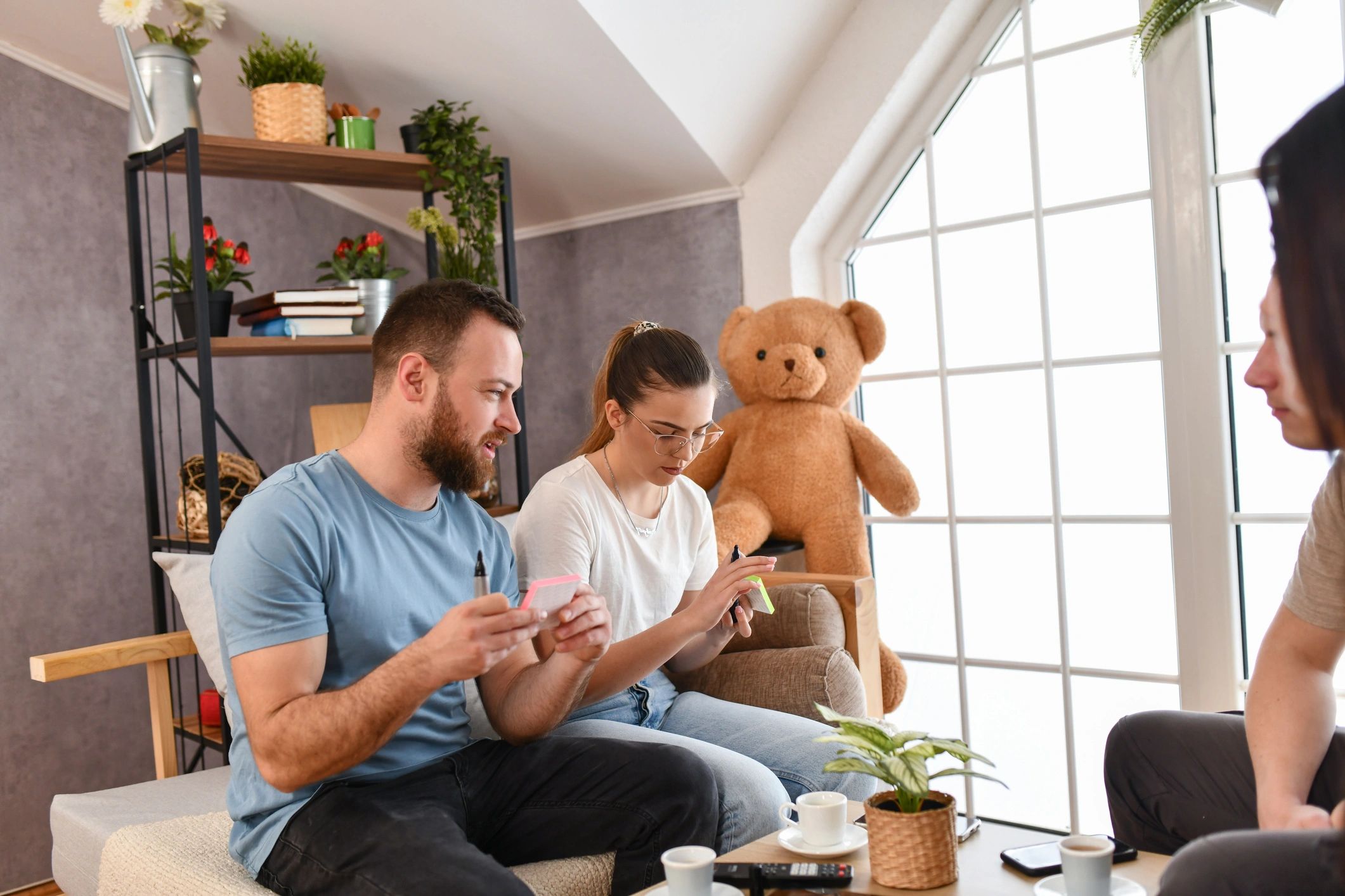 People enjoying a playful guessing game around a cozy table