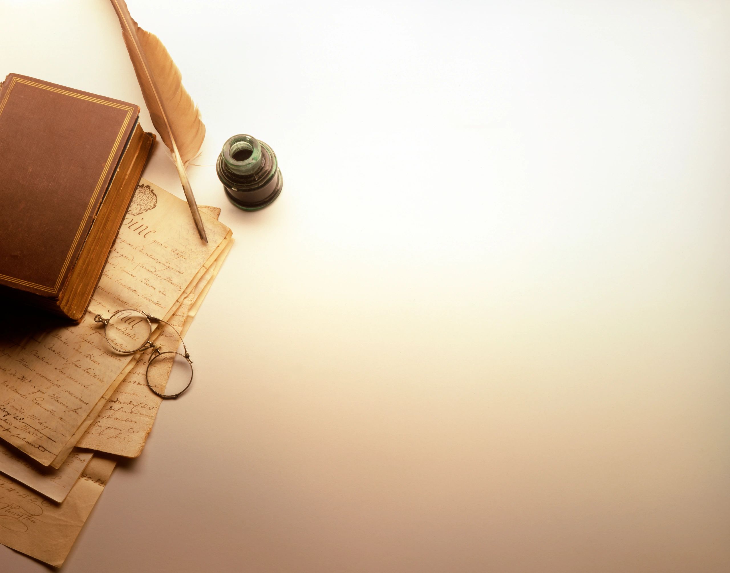 Antique documents, book, and quill arranged like mystery clues