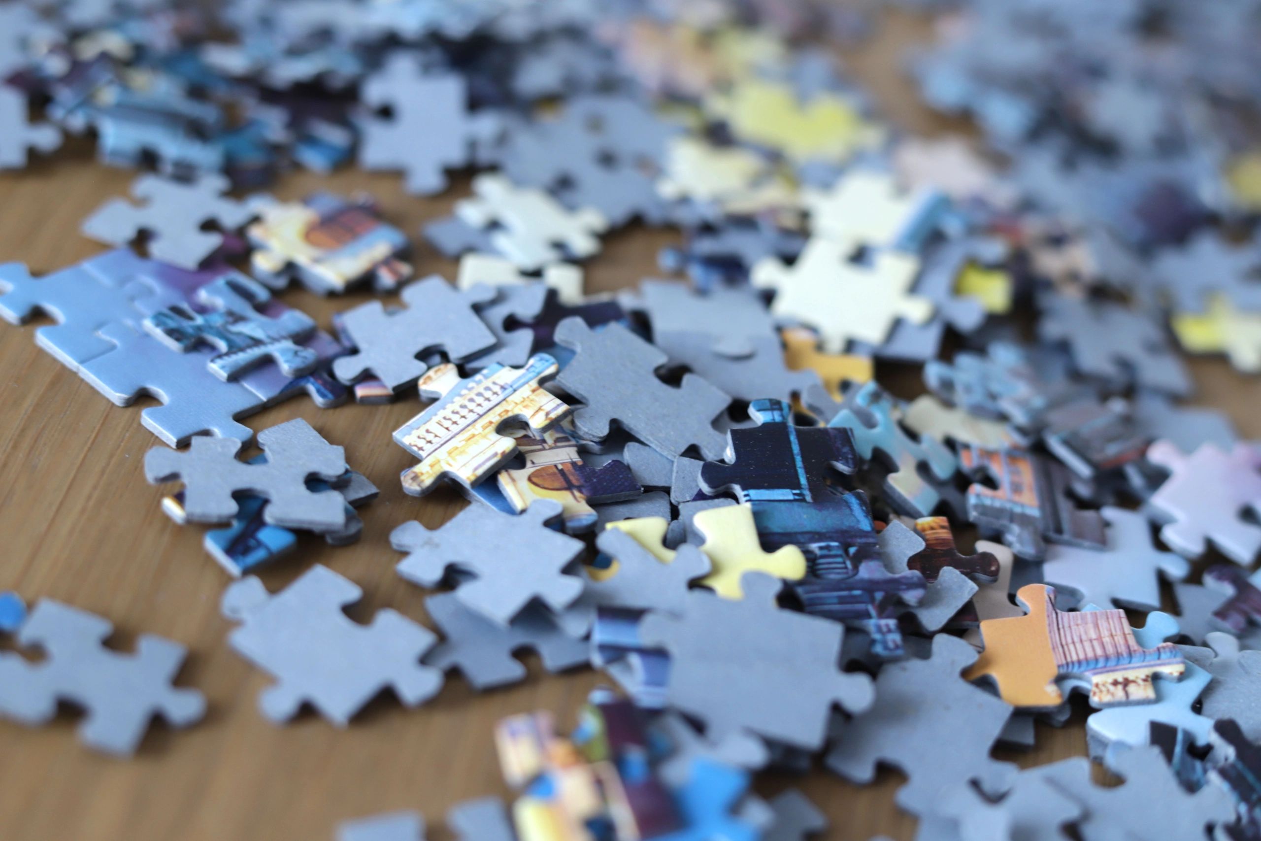 Mixed jigsaw puzzle pieces on a table